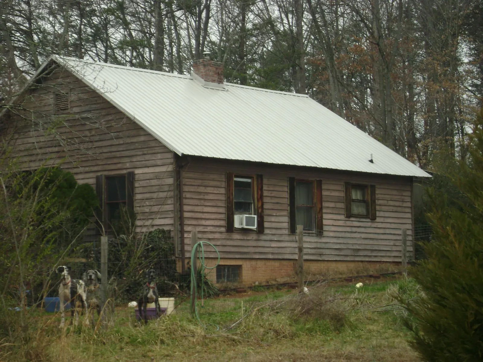White metal roof on an old wood sided farmhouse, from a Metal Roof Installation job in Beverly Hills